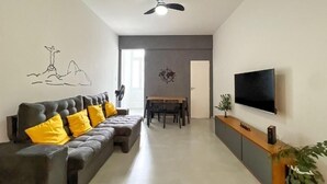 A modern living room with a sofa, dining table, and TV. - Rio Select - Copacabana  (Rio de Janeiro)