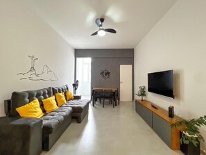 A modern living room with a sofa, dining table, and TV. - Rio Select - Copacabana  (Rio de Janeiro)