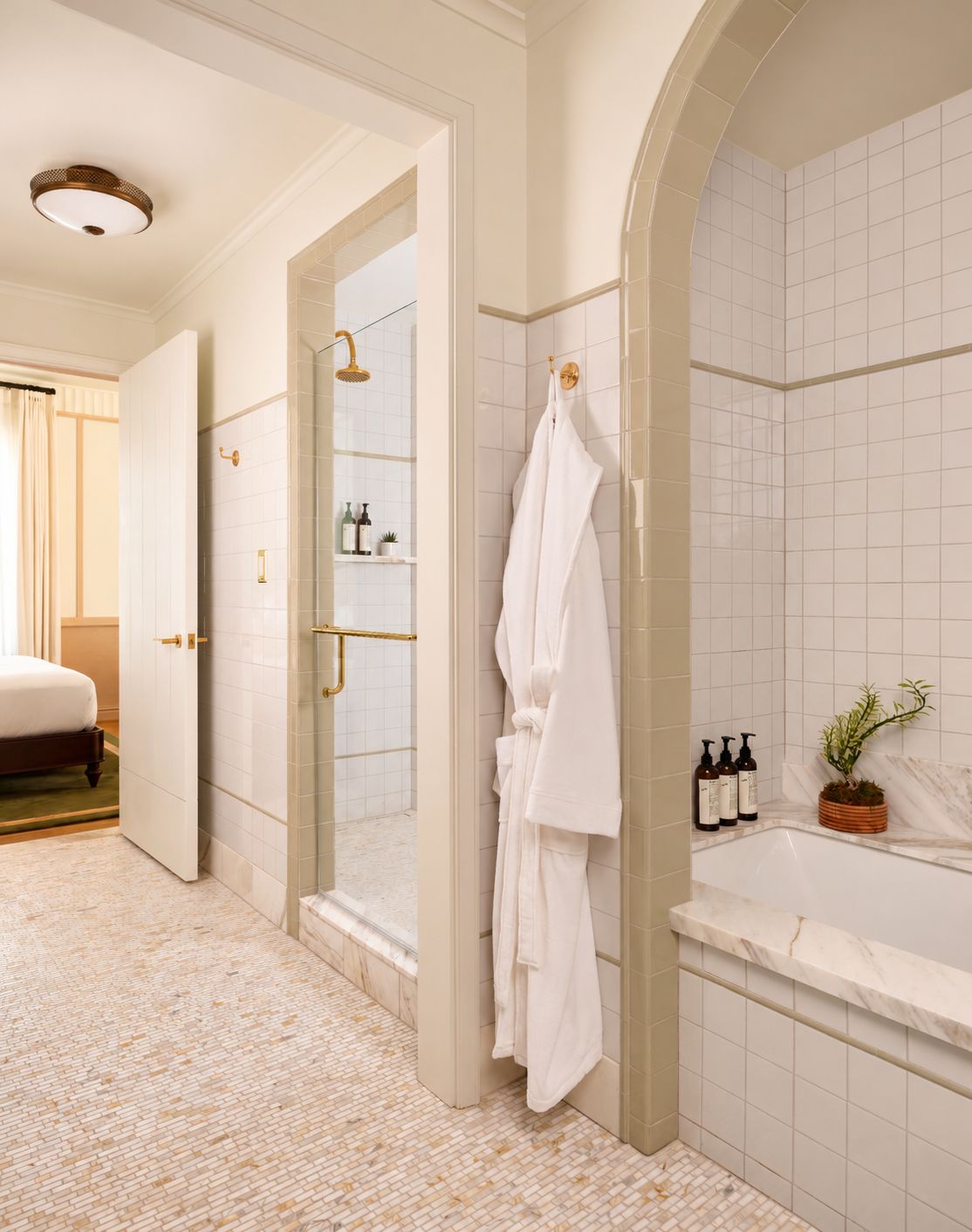 A hotel bathroom with a walk-in shower, a bathtub, and a toilet.