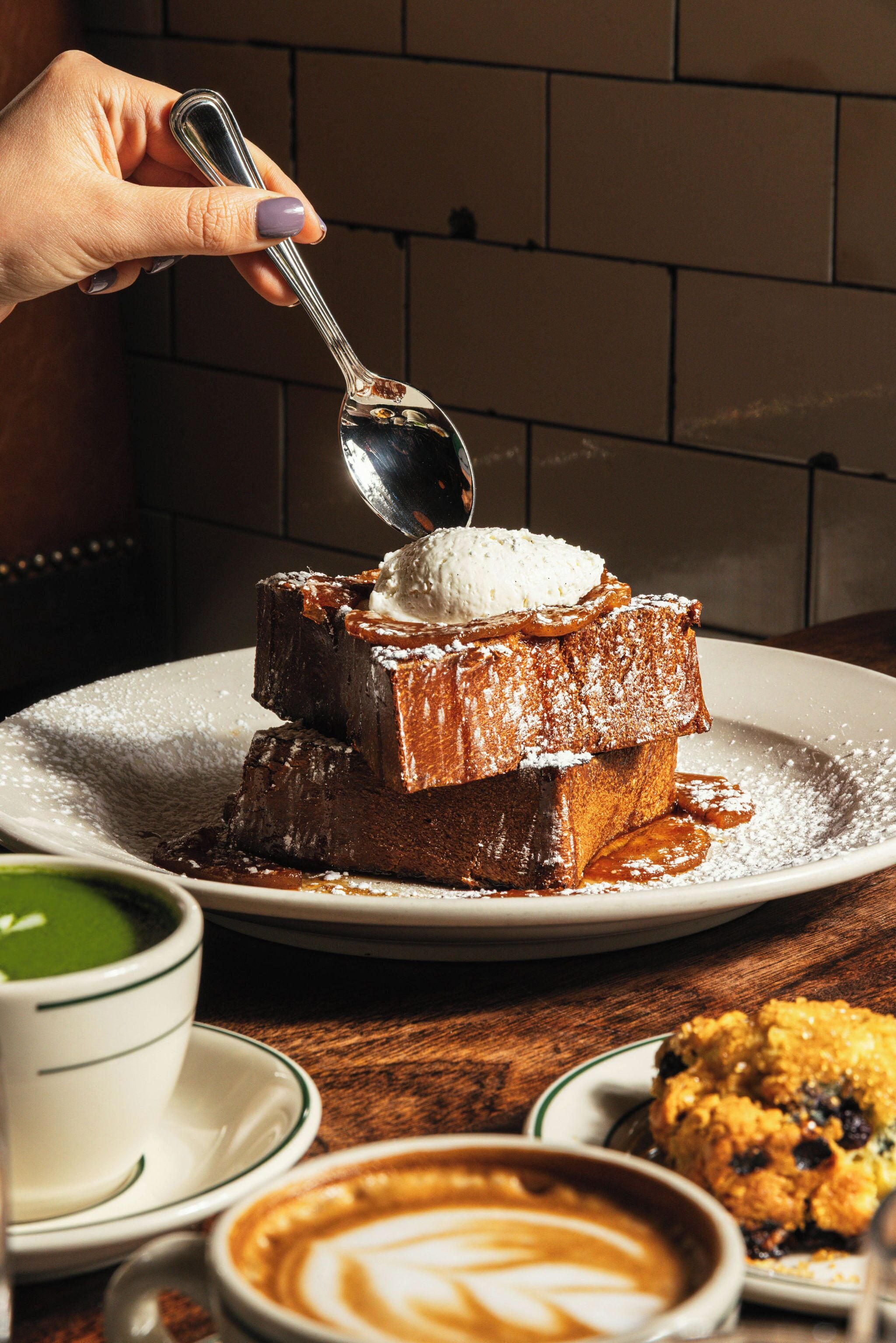 A dessert with ice cream on a plate, a cookie, and a cup of coffee.