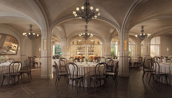 A spacious dining hall with high arched ceilings, multiple chandeliers, and a central bar area.