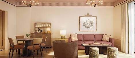 A modern living room with a sofa, coffee table, chairs, and a dining area with a table and chairs.