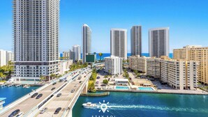 A high-rise hotel with a marina and a clear blue sky. - Beautiful Apt w/ Private Balcony + Incredible Pool (Hallandale Beach)