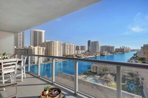 A balcony with a view of a city skyline and a marina. - Stunning Views | Designed Luxe | Resort Stay (Hallandale Beach)