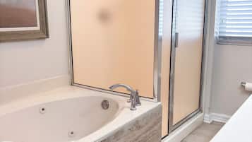 Jetted tub, hair dryer, towels, toilet paper