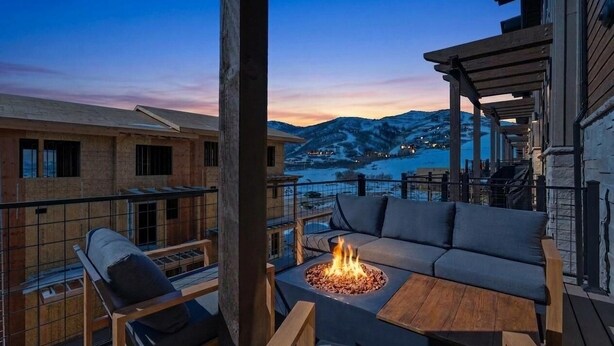 A balcony with a fire pit, outdoor seating, and a view of mountains. - Lake and Lift Lodge at Gondola Crossing (Heber City)