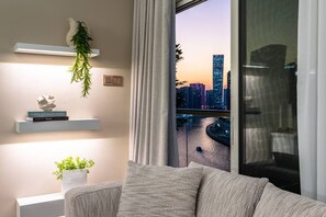 TV, fireplace - Waterfront Escape | Burj & Canal View | Pool+Sauna (Dubai)