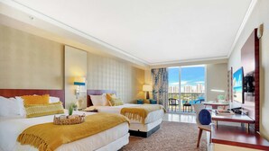 A hotel room with two beds, a desk, a chair, a TV, and a large window with a city view. - Cozy Studio Balcony & Access to Sandy Beach (Sunny Isles Beach)