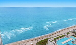 A beach resort with a pool, beach area, and ocean view. - 2BR Apt w/ Beautiful Ocean View, Amenities & Pool (Hollywood)