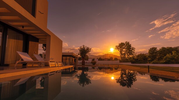 A modern house with a swimming pool reflecting the sunset. - Viridian Exclusive Villas (Sithonia)