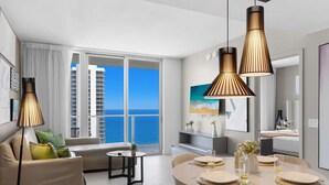 A modern hotel room with a balcony, a dining area with a round table, and a large abstract painting. - Amazing 2BR Apt w/Oceanfront Balcony | Hot Tub (Hollywood)