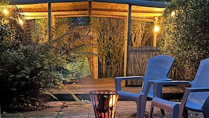 A patio with a fire pit, outdoor seating, and a lantern. - Traditional 1850s fisherman’s cottage, perfect coastal retreat, sea views. (Scratby)