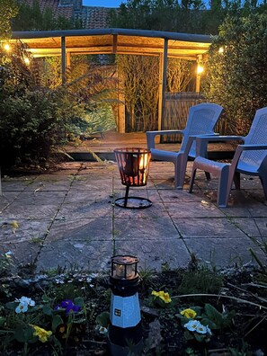 A patio with a fire pit, outdoor seating, and a lantern. - Traditional 1850s fisherman’s cottage, perfect coastal retreat, sea views. (Scratby)