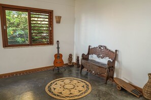 A room with a large window, a guitar, a bench, a woven mat, and a skateboard. - Summerville #159 - House With Pool by Carpediem (Caucaia)