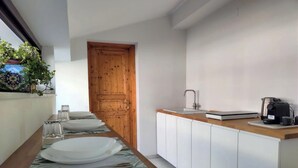 A modern kitchen with a wooden countertop, white cabinets, and a built-in sink. - Cozy and spacious apartment in the heart of the historic center of Catania (Catania)