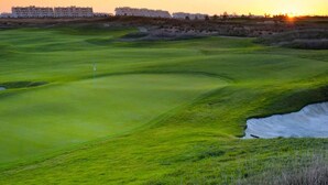 A golf course with a putting green, sand bunkers, and a flagstick. - Condado De Alhama Apt-pool-park-parking-sleeps4 (Alhama de Murcia)