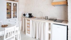 A compact kitchen with a white cabinet, a coffee maker, a sink, and a small refrigerator. - Apulian Charm STELLA (Martina Franca TA)
