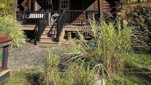 A rustic cabin with a wooden exterior, a porch, and a chimney. - Log Cabin on the Clarion River! The Dam Inn 1 mile, 5 miles to East Branch Dam (Wilcox)