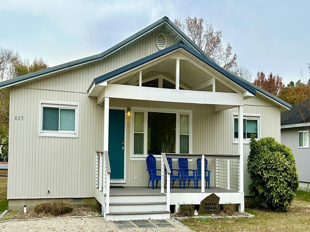 A single-story house with a porch, a small front yard, and a mailbox.