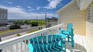 A balcony with blue Adirondack chairs and a view of the beach and ocean. - A Beach Escape- 1973 New River Inlet Rd (North Topsail Beach)