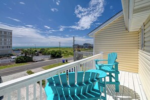 A balcony with blue Adirondack chairs and a view of the beach and ocean. - A Beach Escape- 1973 New River Inlet Rd (North Topsail Beach)