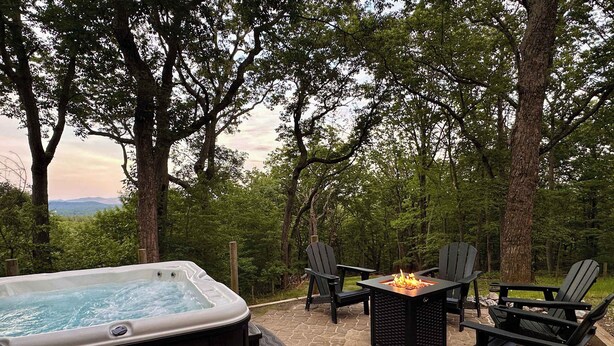 An outdoor hot tub area with a fire pit and Adirondack chairs. - Prime Location! 5 Min to National Park & Wineries (Afton)