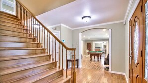 A wooden staircase leading to a living area with a pool table. - Rancho Vista Estate on 3 acre, Private grapevines (Temecula)
