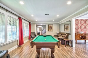 A pool table in a room with wooden flooring, a sofa, and a cabinet. - Rancho Vista Estate on 3 acre, Private grapevines (Temecula)