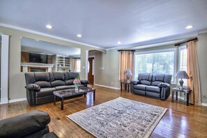 A spacious living room with two leather sofas, a coffee table, and a patterned rug. - Rancho Vista Estate on 3 acre, Private grapevines (Temecula)