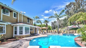 A swimming pool with lounge chairs, a covered patio, and a house with a covered porch. - Rancho Vista Estate on 3 acre, Private grapevines (Temecula)