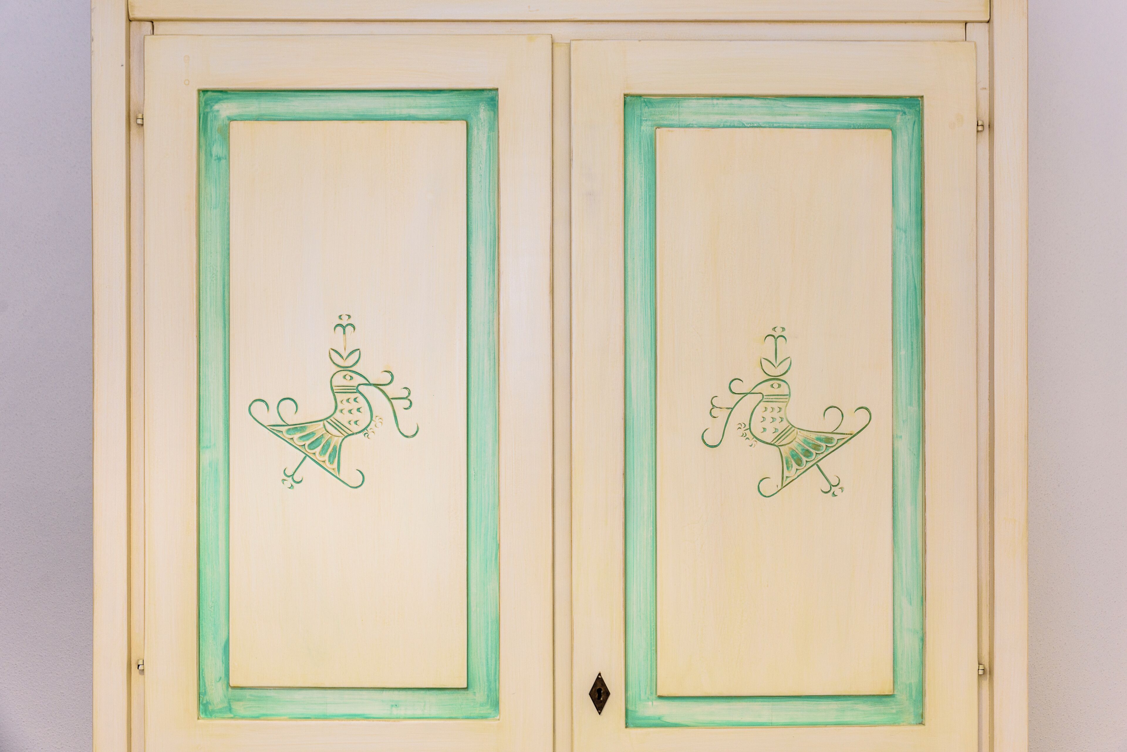Two doors with a simple design and a small decorative element in the center.
