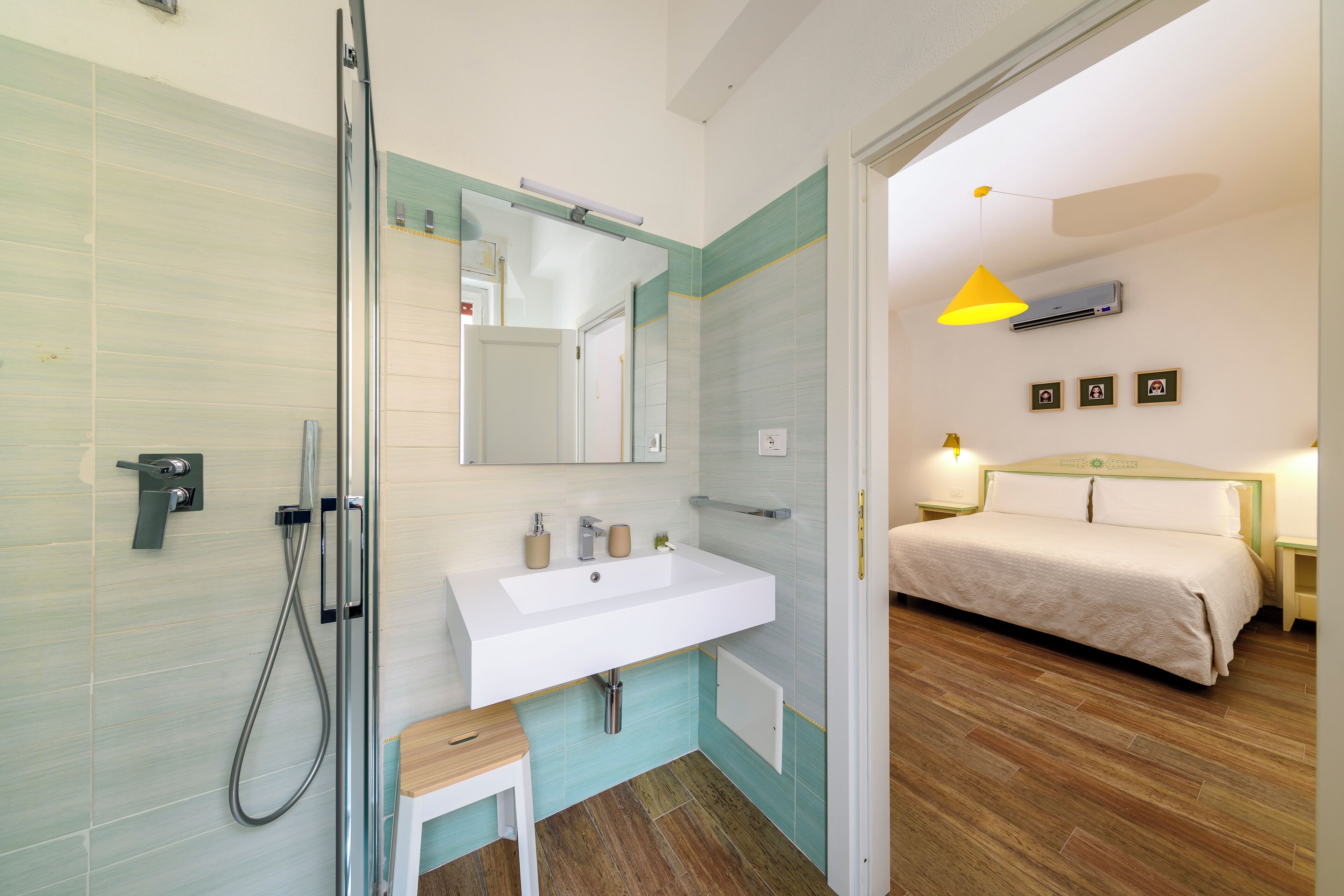 A bathroom with a shower, sink, and mirror.