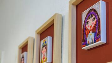 A series of framed artworks on a wall.