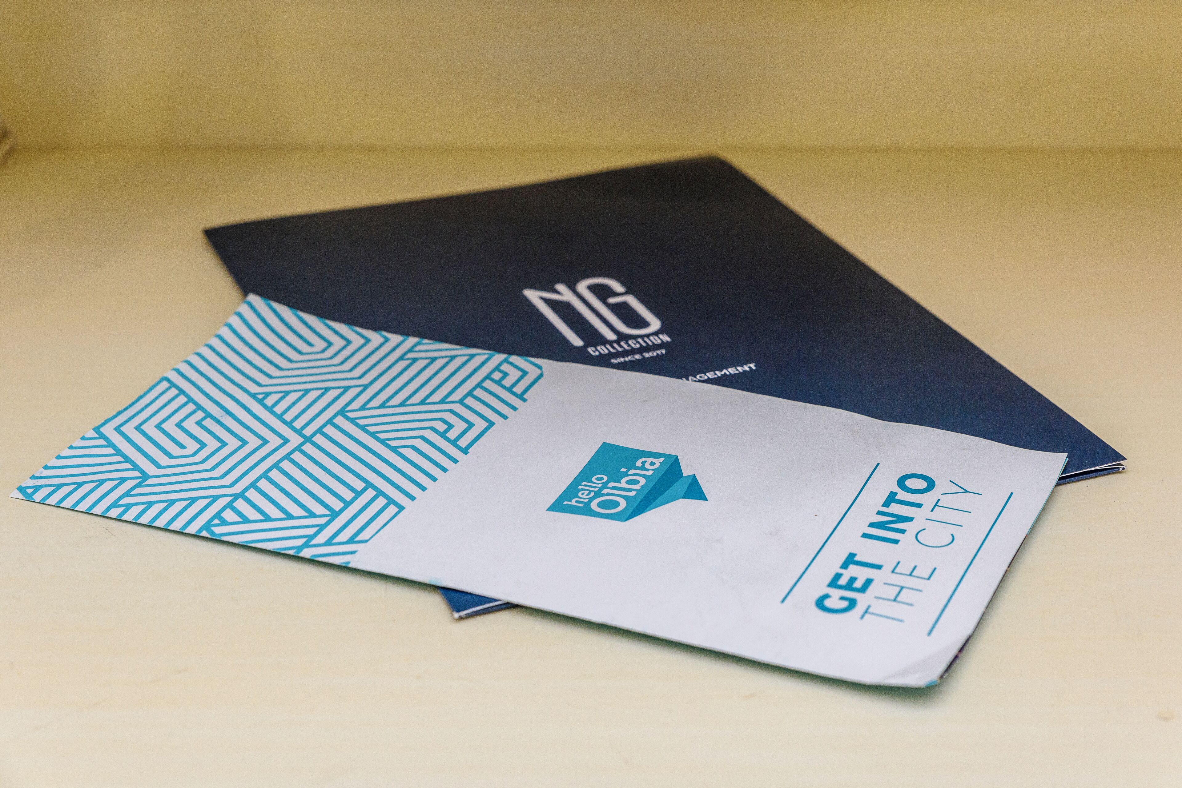 Two brochures with text and geometric patterns.