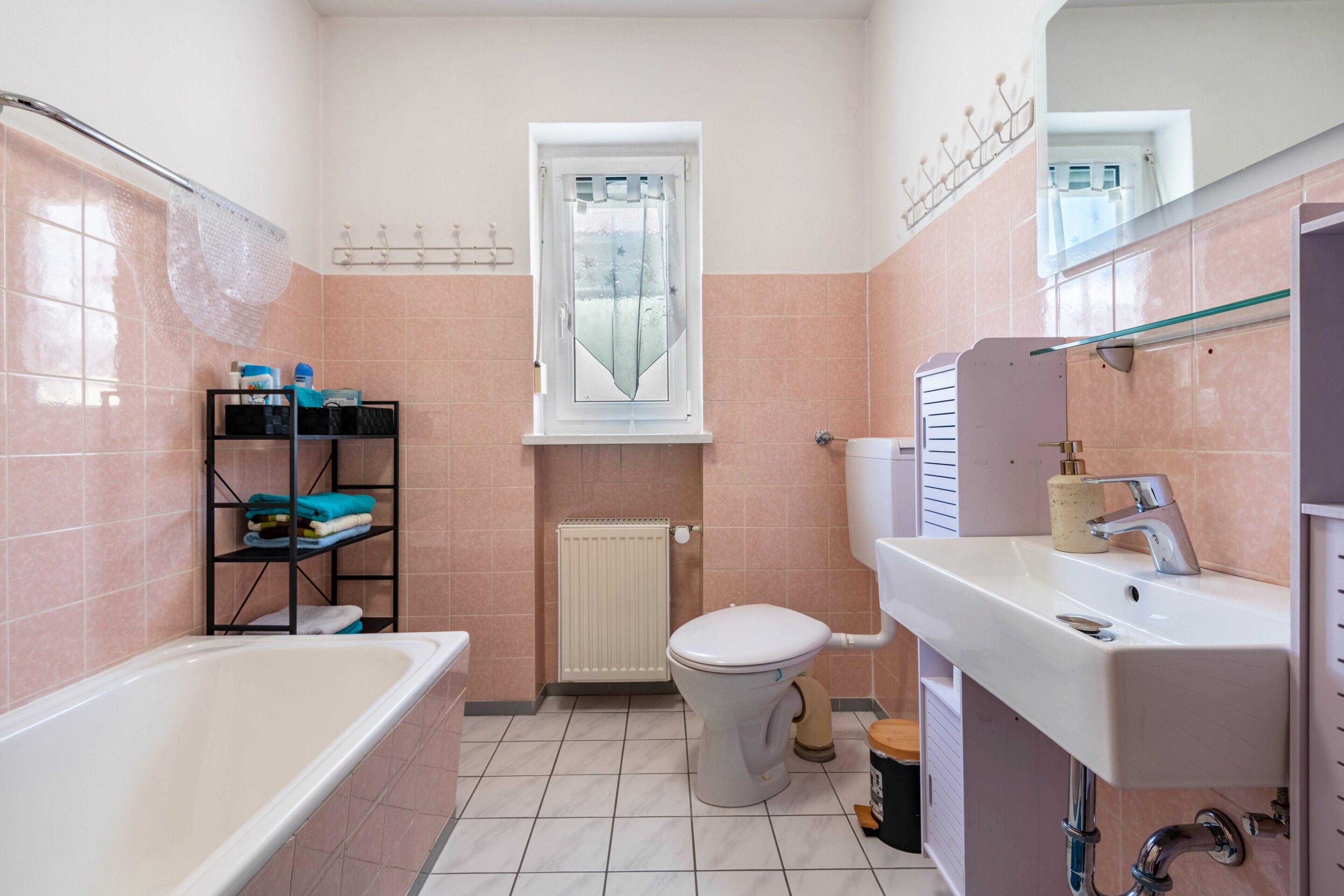 A bathroom with a bathtub, toilet, and sink.