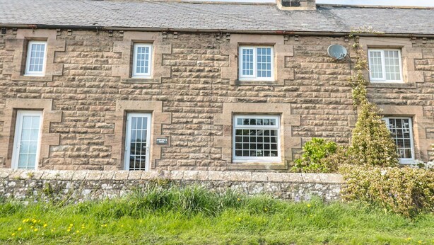 A stone building with multiple windows and a chimney. - Shepherds Nook (Chathill)