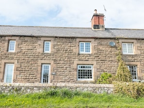 A stone building with multiple windows and a chimney. - Shepherds Nook (Chathill)