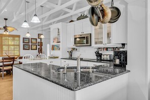A modern kitchen with granite countertops, stainless steel appliances, and pendant lighting. - Serenity Bay Estate-FL Keys Best Kept Secret! Beautiful, Quiet, Tropical Pardise (Marathon)