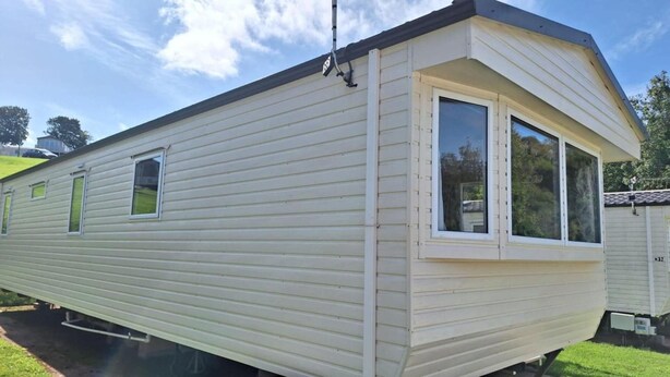 A mobile home with a single large window and a smaller window on the side. - Sheena Beautiful Static Caravan Hoburne Devon Bay (Paignton)