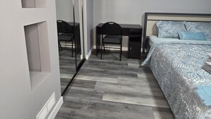 A modern bedroom with a bed, a desk, and a chair. - Sally Room 101-Place in Devonshire Park (Winnipeg)