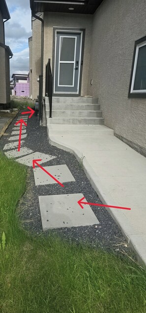 A pathway leading to a house with a door and steps. - Yekky Room 101-Place in Devonshire Park (Winnipeg)