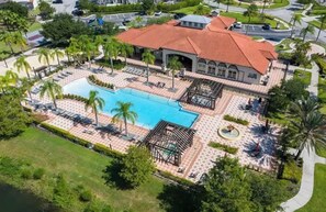 An aerial view of a resort with a large swimming pool, lounge areas, and a pavilion. - Sweet Retreat At Bella Vida (Kissimmee)