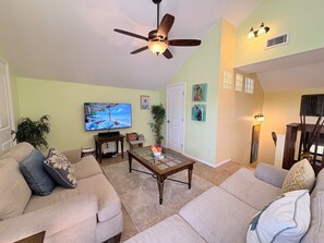A living room with a ceiling fan, a television, a coffee table, and a sofa. - Blue Macaw North Captiva Island (North Captiva)