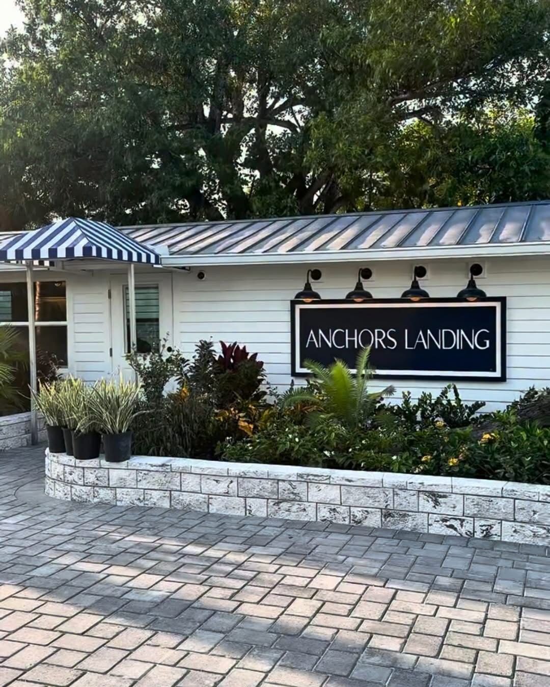 A building with a sign reading 'ANCHORS LANDING' and a covered porch area.
