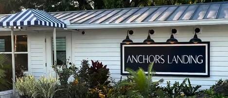 A building with a sign reading 'ANCHORS LANDING' and a covered porch area.