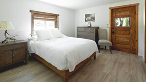 A bedroom with a wooden bed, a dresser, a chair, a wooden door, and a window with blinds. - Ranch Retreat in Wine Country - Horses & Views! (Santa Ynez)