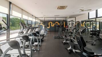 A gym with treadmills, elliptical machines, and weight equipment.