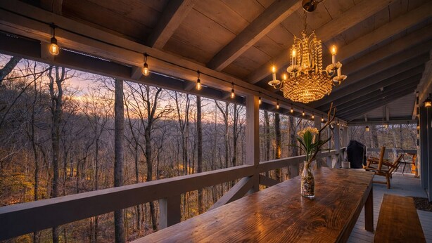 A wooden deck with a table and chairs, overlooking a forested area. - Near Toccoa River • Hot Tub • Fire Pit • Gameroom - Holiday Home (Blue Ridge)