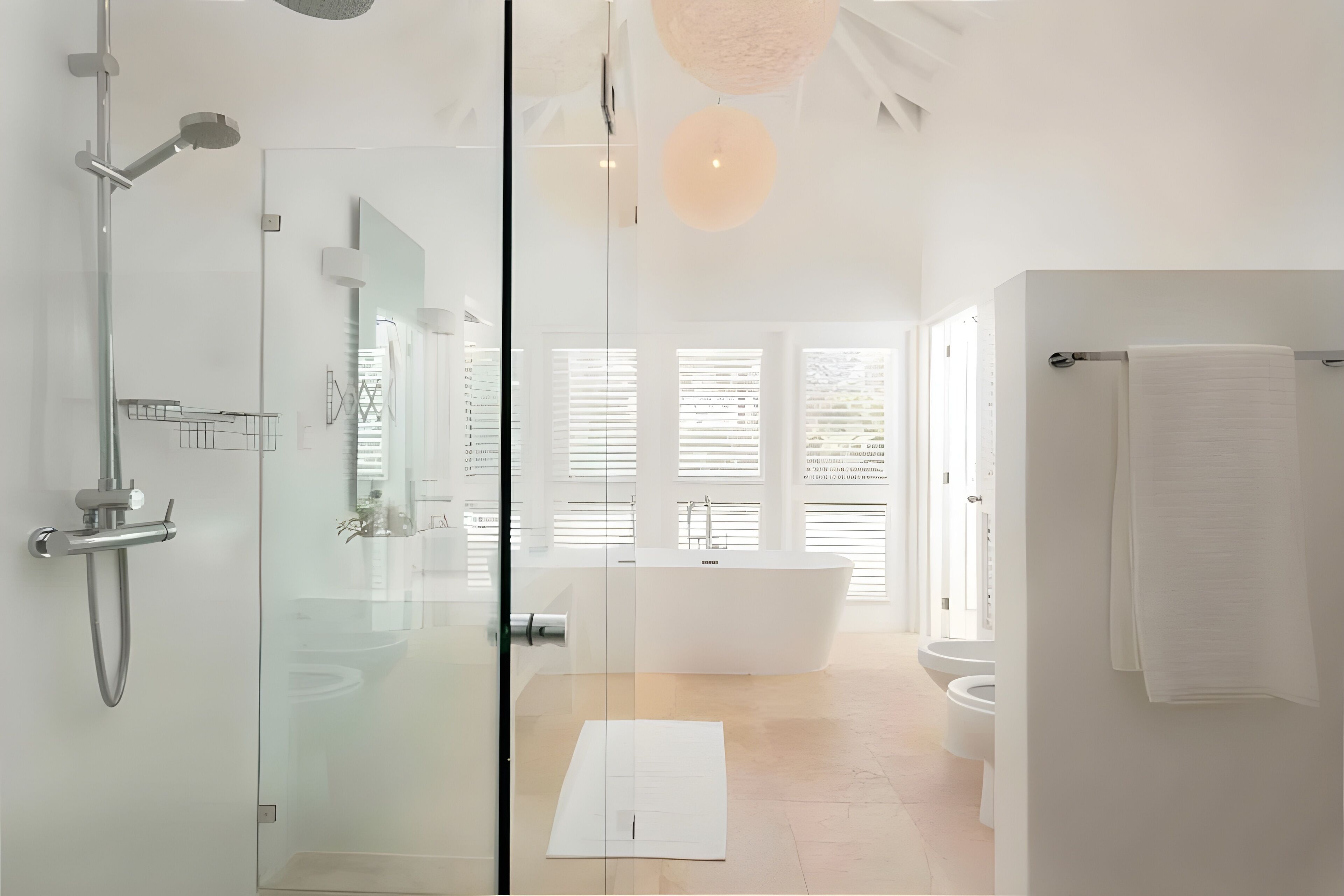 A modern bathroom with a glass-enclosed shower, a freestanding bathtub, and a toilet.