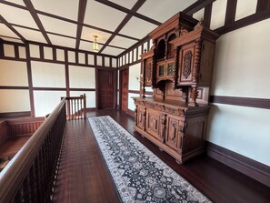 A spacious room with a high ceiling, dark wooden floors, and a large wooden cabinet with intricate carvings. - Marvelous 1-bedroom bed & breakfast in charming Lebanon PA (Lebanon)